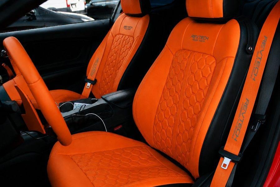 Ford Mustang interior with orange leather upholstery by REVTECH